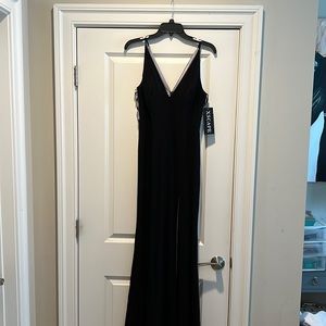 Long black Xscape gown. Illusion detail on the sides. Tags on, never worn